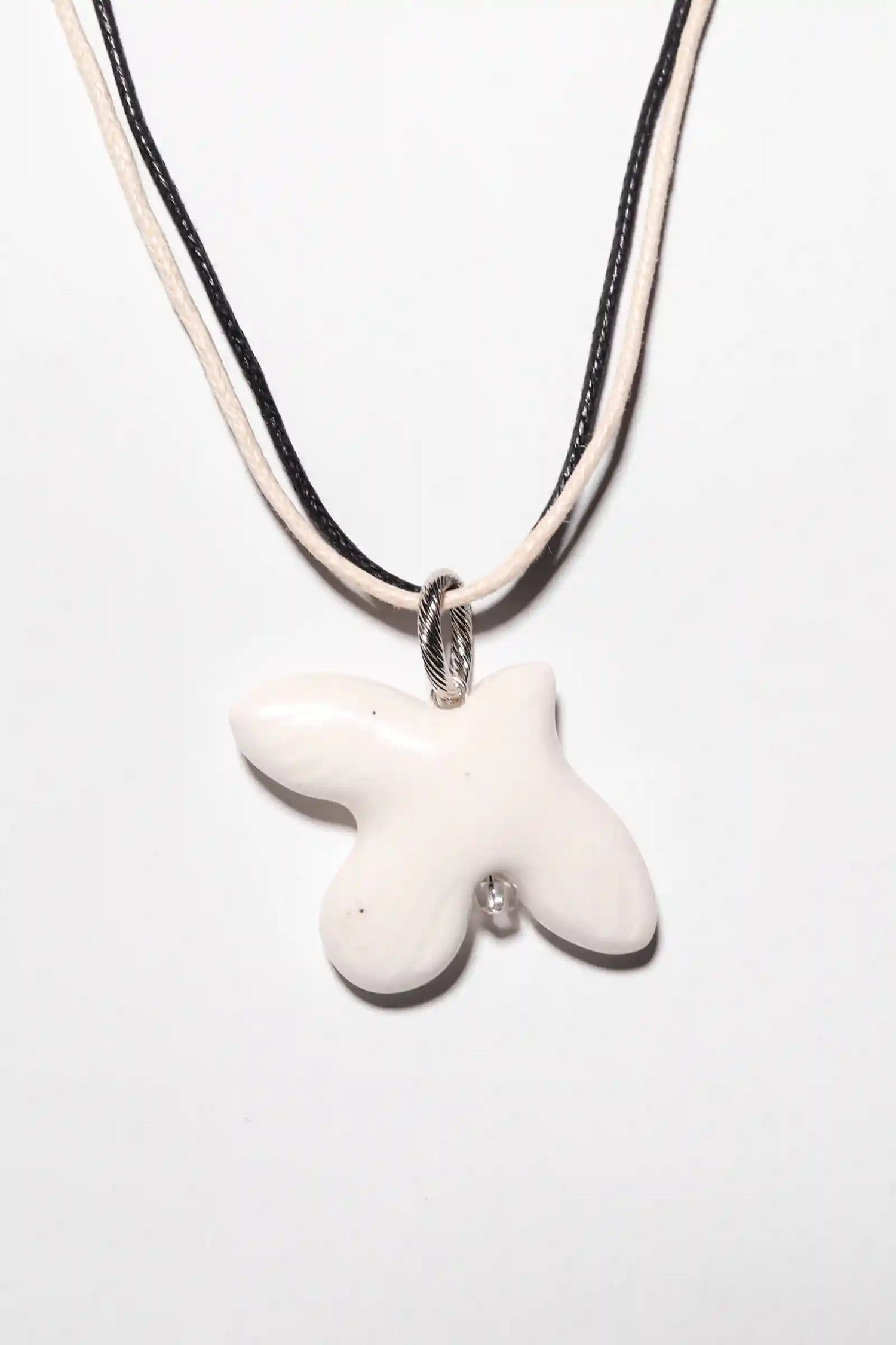 WABI-SABI bird pendant on a cord