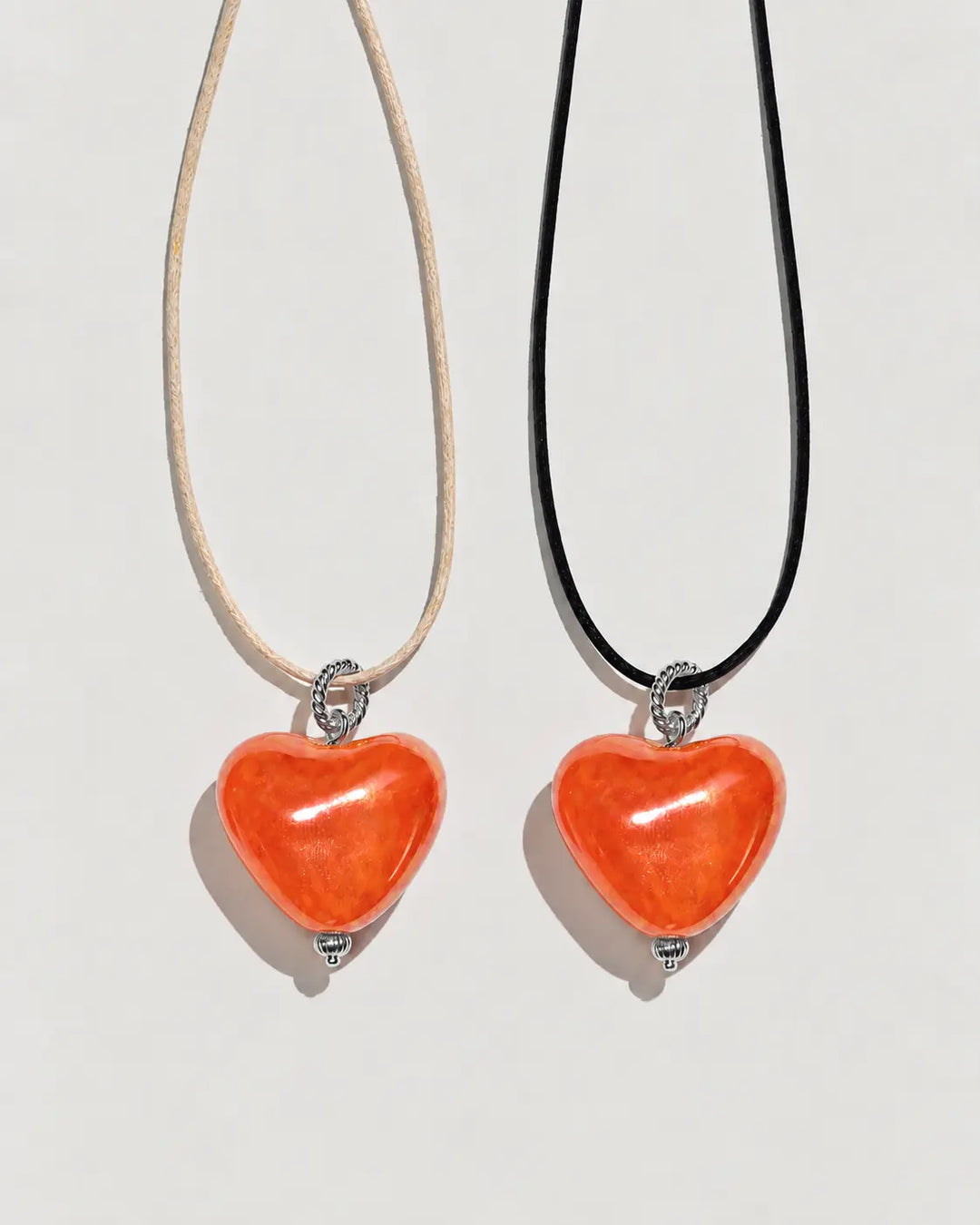 Pendant SKARB small orange heart on a cord, silver hardware