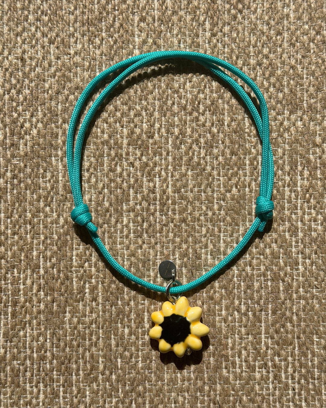SUNFLOWER dog pendant with a blue cord