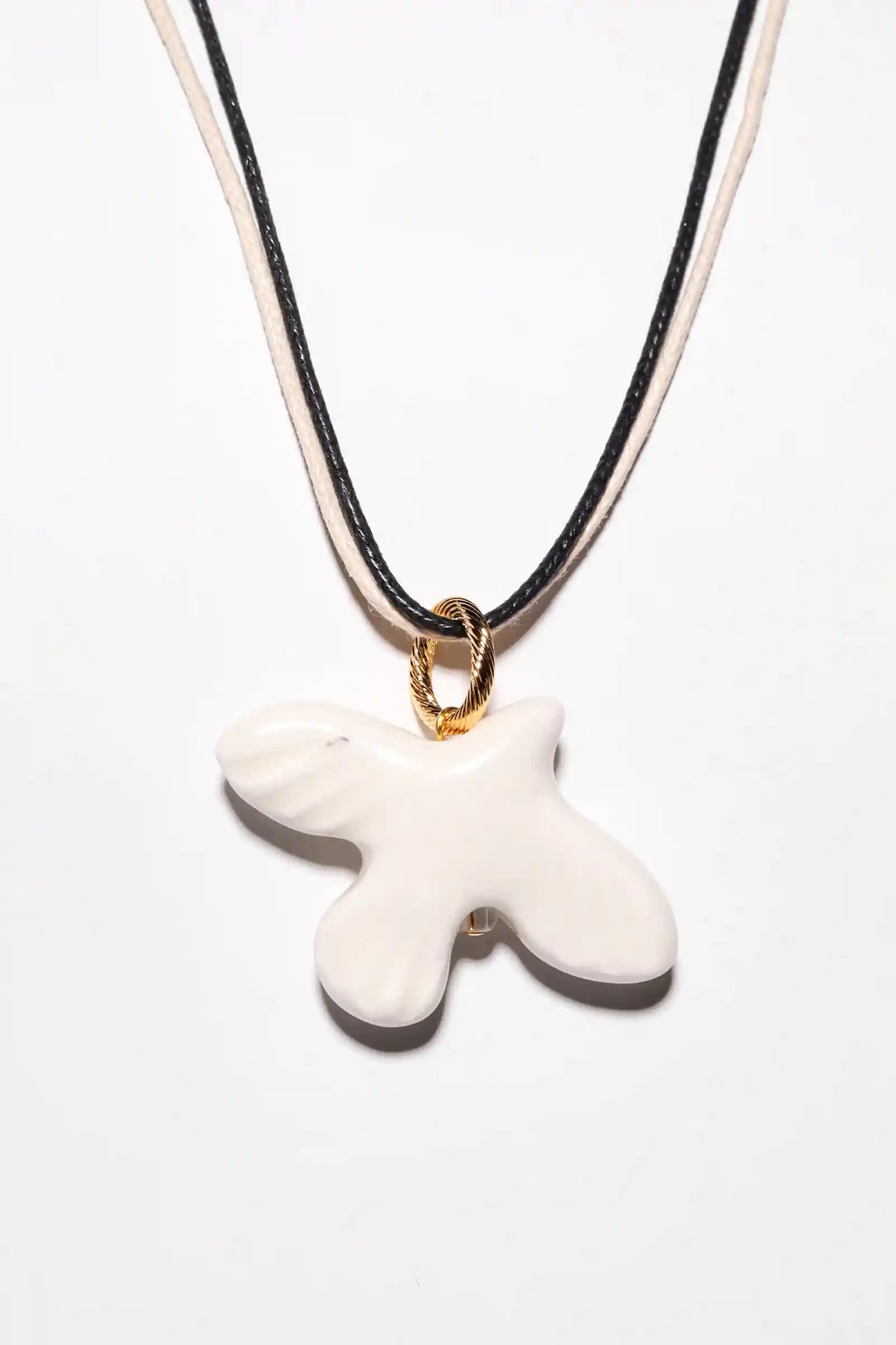 WABI-SABI bird pendant on a cord